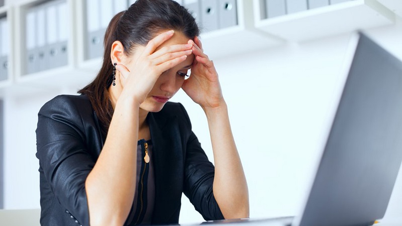 Portrait of tired young business woman with laptop at the office ; Shutterstock ID 148515530; PO: today.com